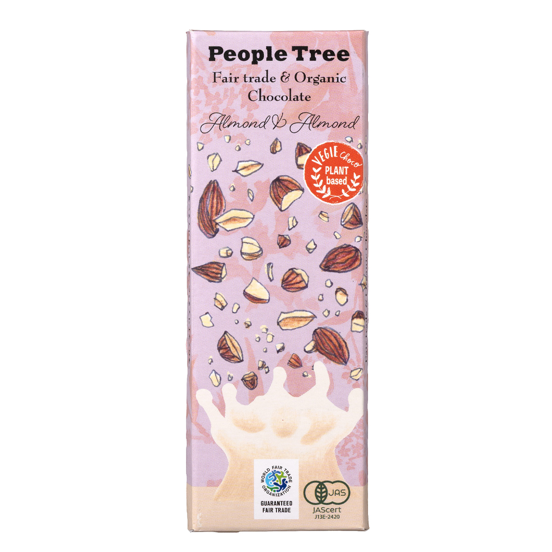 Pink packaging of People Tree almond chocolate with illustrations of almonds and a splash of milk. Labels show fair trade and vegan-friendly.