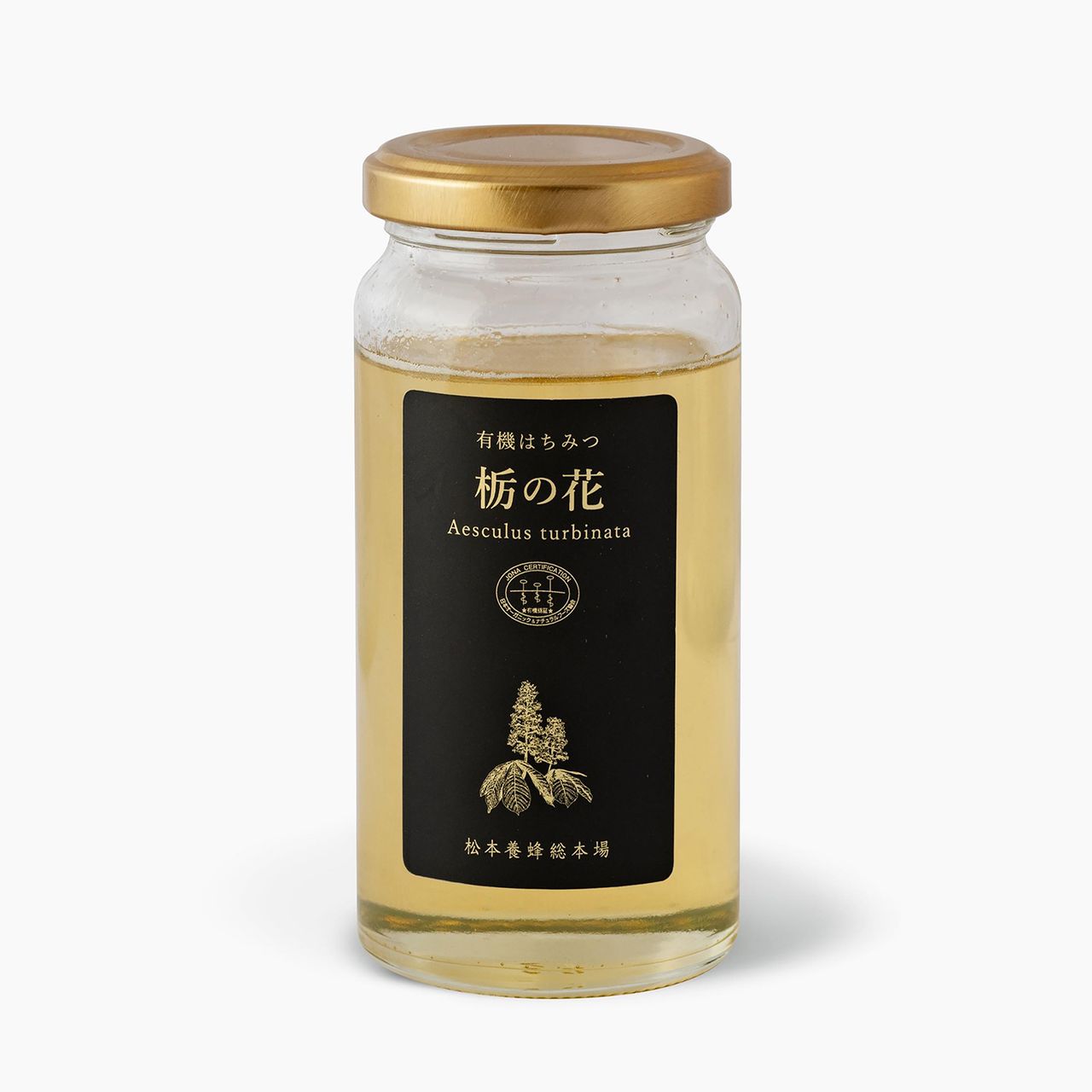 Glass jar with golden lid containing light liquid. Black label with Japanese text and "Aesculus turbinata" in white, featuring a plant illustration.