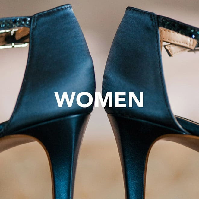 Close-up of elegant high-heeled shoes with the word "WOMEN" overlaid in bold white text.